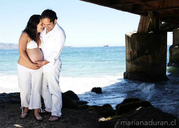 Couple by the sea expecting baby