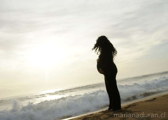 embarazada mirando las olas del mar